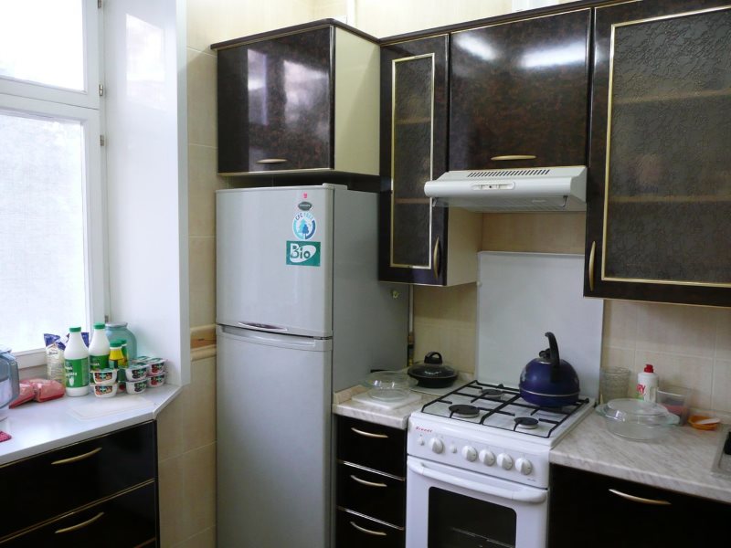 Черный гарнитур в кухне с холодильником