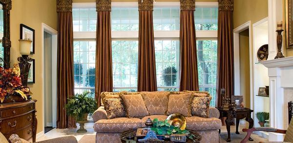 Для окон гостиной, выполненной в классическом стиле, отлично подойдут шторы коричневого цвета из атласа 